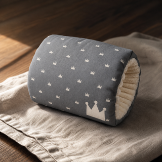 Coussin de bras gris à motifs couronnes, vu de côté avec son ouverture rembourrée.